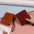 Portable short wallet 2024 spring/summer new Japanese and South Korea PU leather solid color zipper wrist strap folding can expa